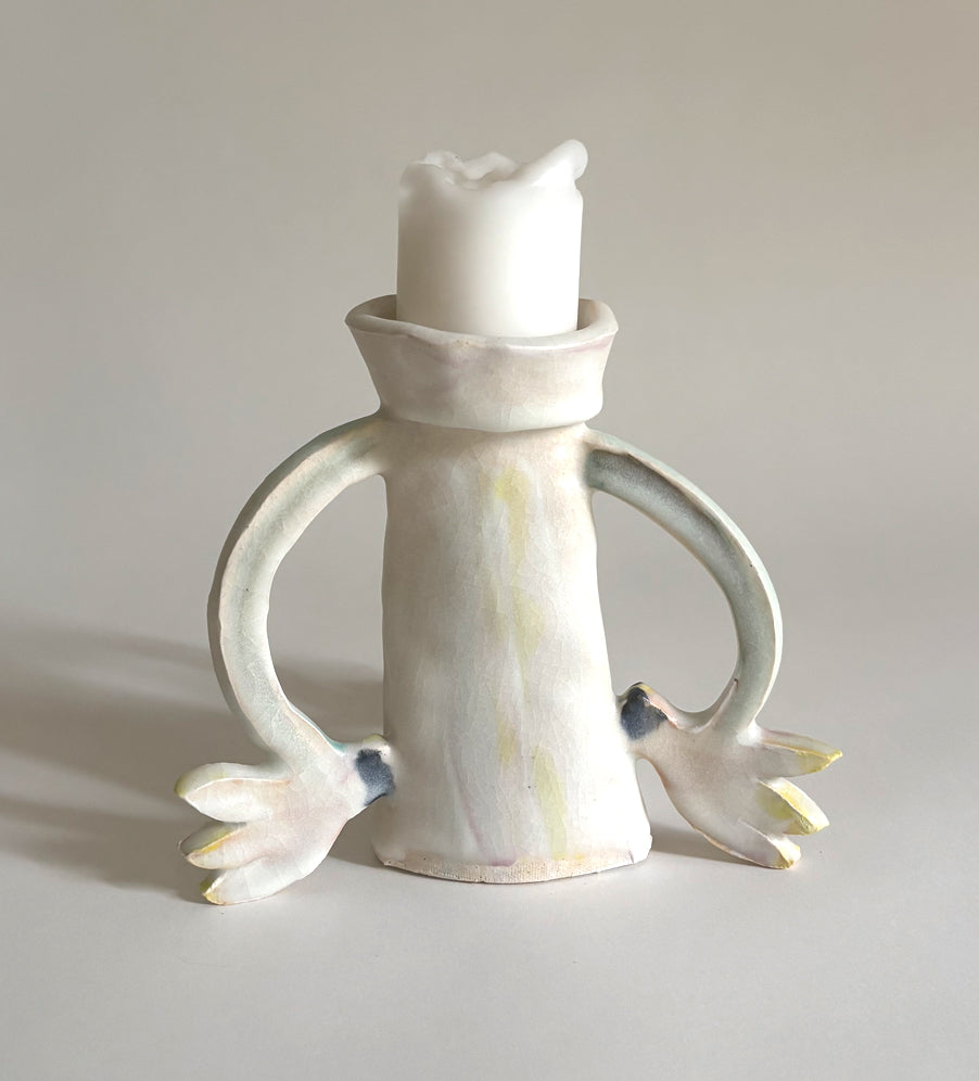 Three Cyclamens holding a candle