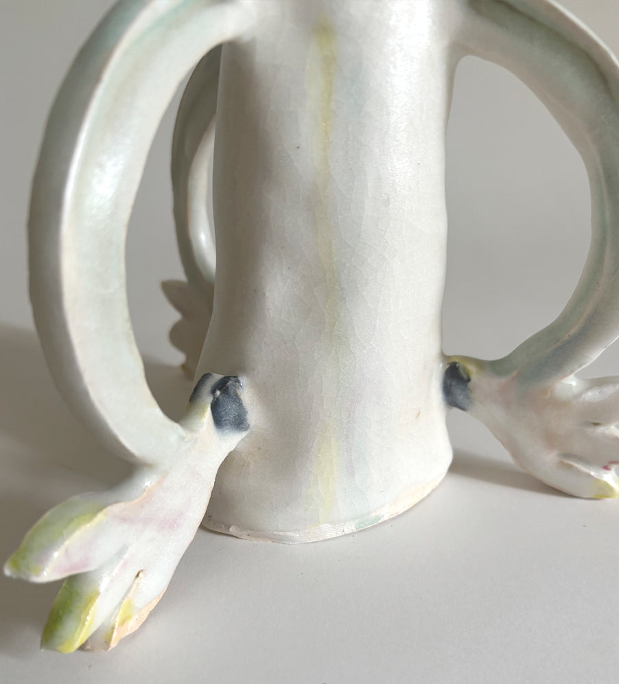 Three Cyclamens holding a candle