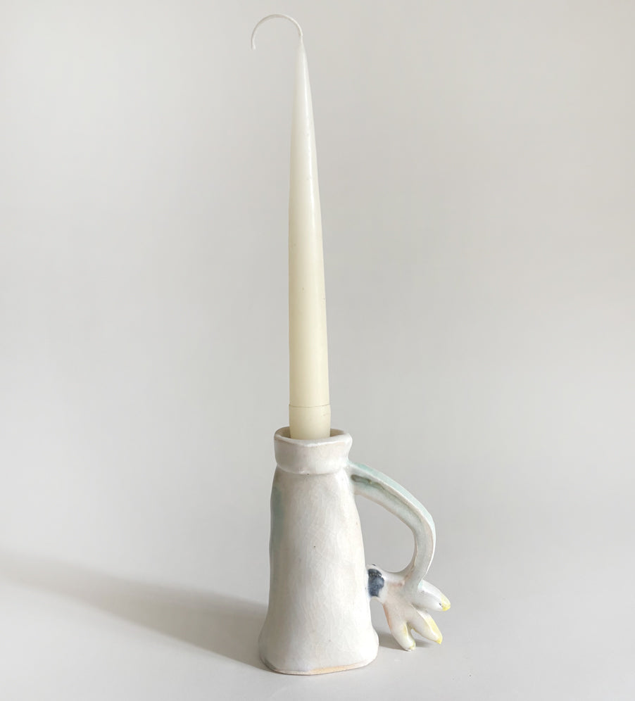 One Cyclamen holding a candle