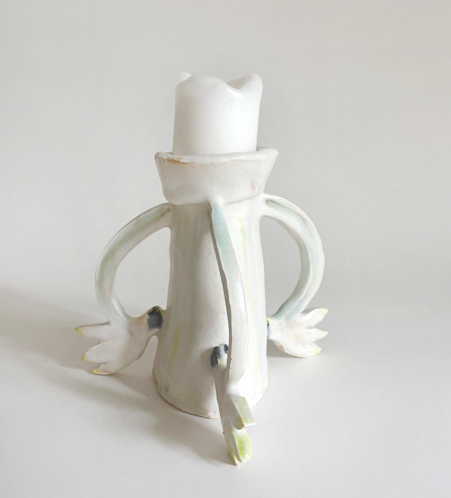 Three Cyclamens holding a candle