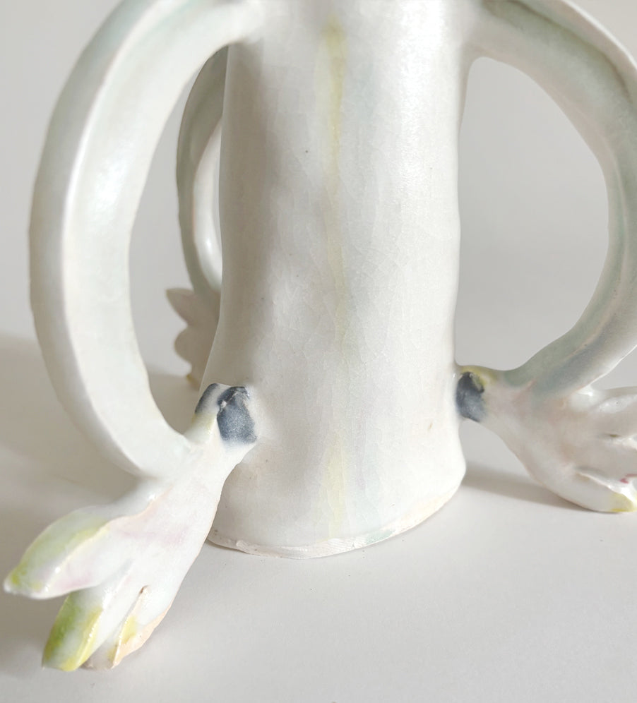 Three Cyclamens holding a candle