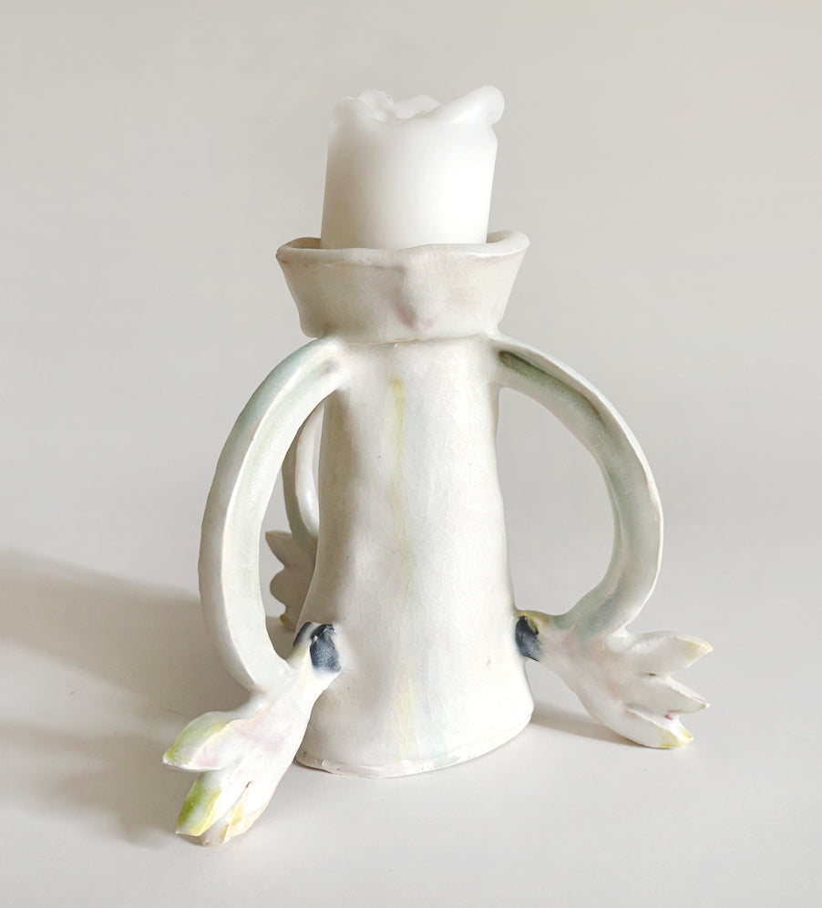 Three Cyclamens holding a candle