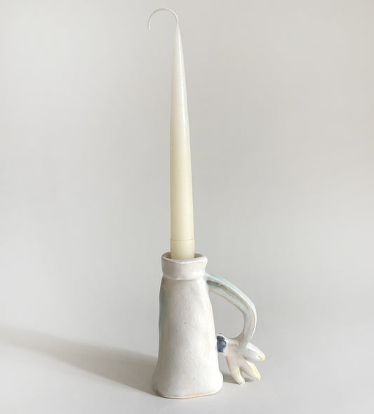 One Cyclamen holding a candle
